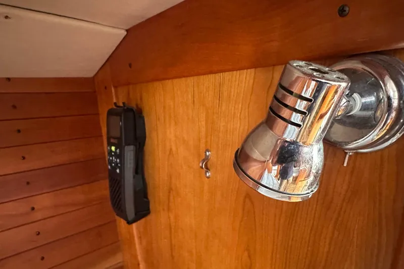 Slide: The Image of Interior of 2004 J Boats J/109 with wooden paneling and mounted light fixture. - 53