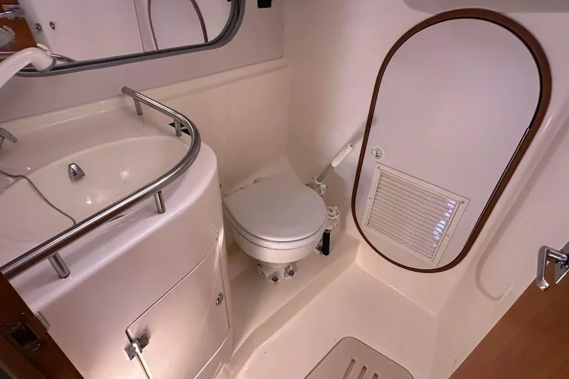 Slide: The Image of 2004 J Boats J/109 yacht bathroom with sink, toilet, and storage compartment. - 58