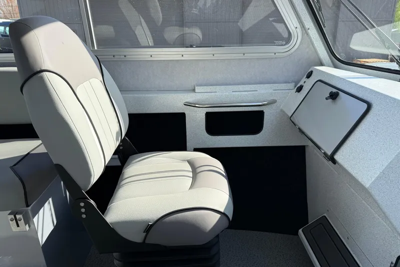 Slide: The Image of Interior of 2026 KingFisher 2425 Escape HT boat, featuring a comfortable captain's chair. - 10