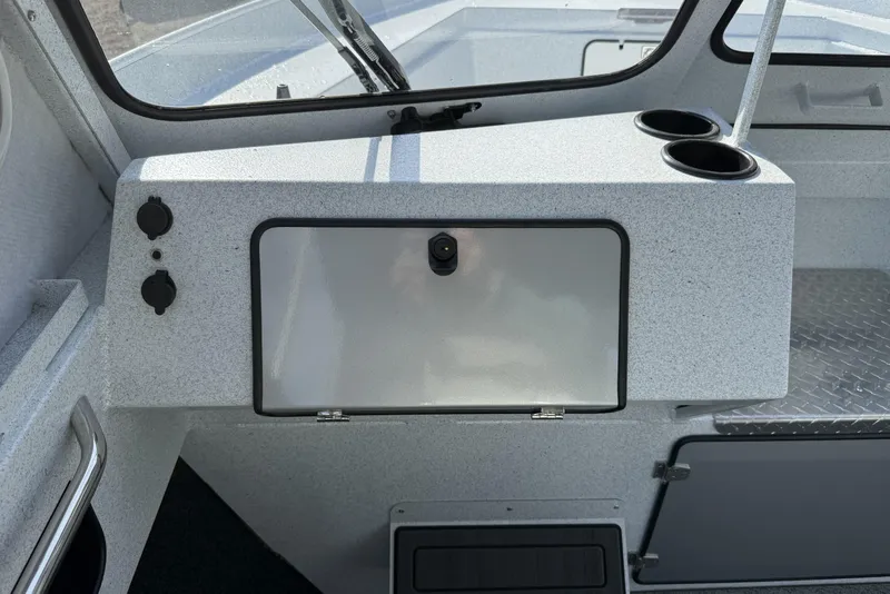 Slide: The Image of Interior of 2026 KingFisher 2425 Escape HT boat, featuring dashboard and cup holders. - 11