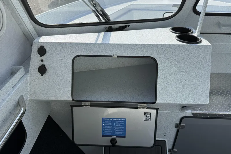 Slide: The Image of Interior of 2026 KingFisher 2425 Escape HT boat with storage compartment and cup holders. - 12