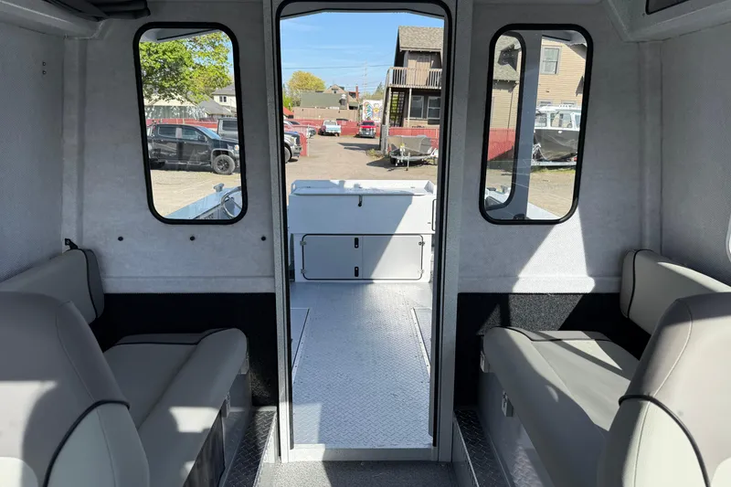 Slide: The Image of Interior of 2026 KingFisher 2425 Escape HT boat, featuring seating and windows. - 13