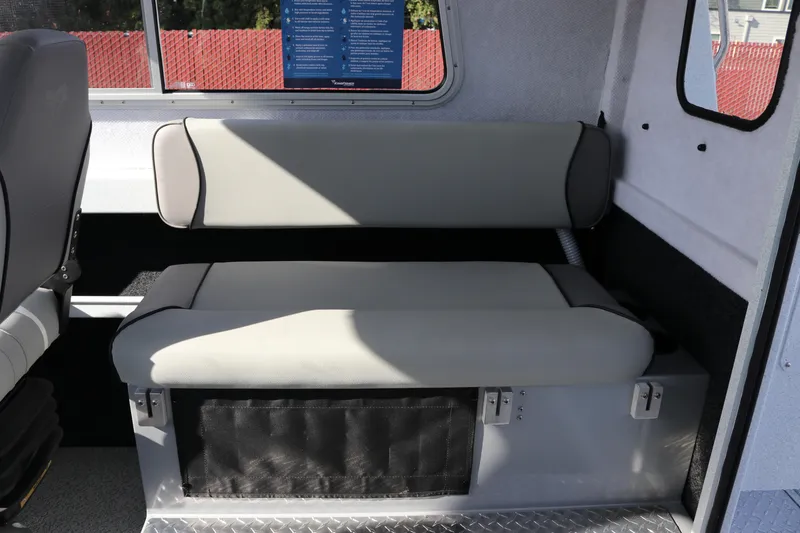 Slide: The Image of Interior seating of 2026 KingFisher 2425 Escape HT boat, featuring gray upholstery. - 14