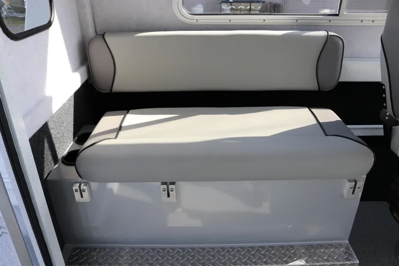 Slide: The Image of Interior seating of 2026 KingFisher 2425 Escape HT boat, featuring gray cushioned bench. - 16