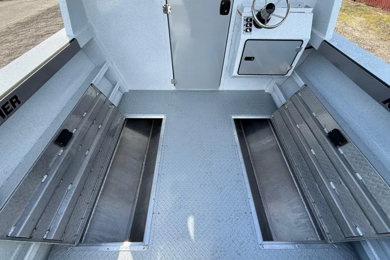 Slide: The Image of Interior of 2026 KingFisher 2425 Escape HT boat with storage compartments and steering console. - 22