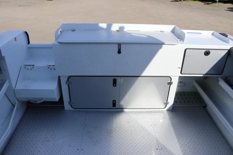 Slide: The Image of 2026 KingFisher 2425 Escape HT boat interior with storage compartments and non-slip flooring. - 23