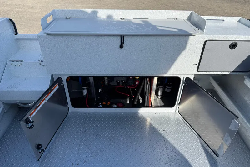 Slide: The Image of 2026 KingFisher 2425 Escape HT boat interior with open storage compartments and visible wiring. - 25