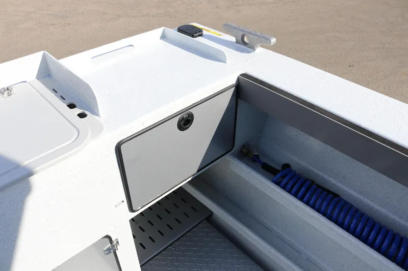 Slide: The Image of 2026 KingFisher 2425 Escape HT boat interior with storage compartment and coiled hose. - 31