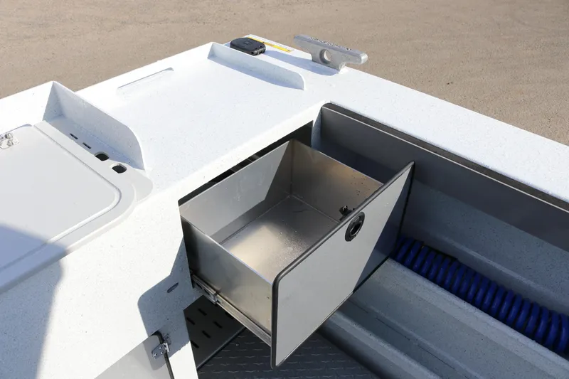 Slide: The Image of 2026 KingFisher 2425 Escape HT boat storage compartment with open drawer and coiled hose. - 32