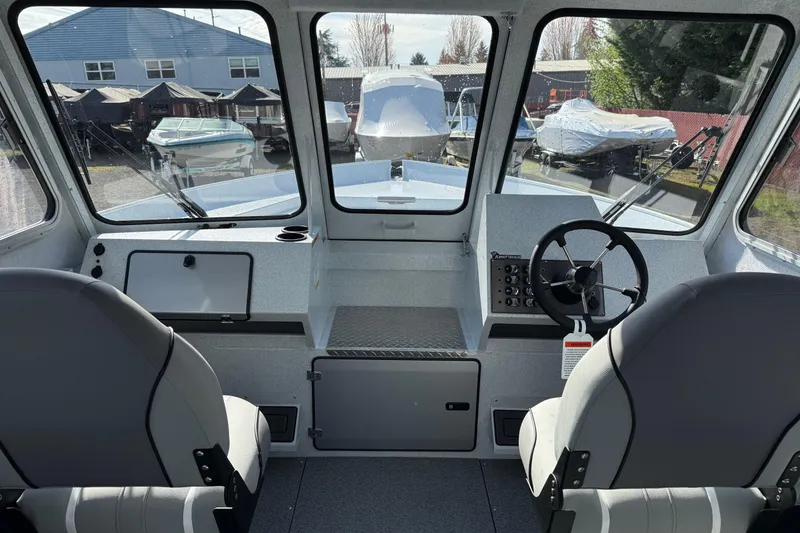 Slide: The Image of Interior view of 2026 KingFisher 2425 Escape HT boat, featuring helm and seating. - 7
