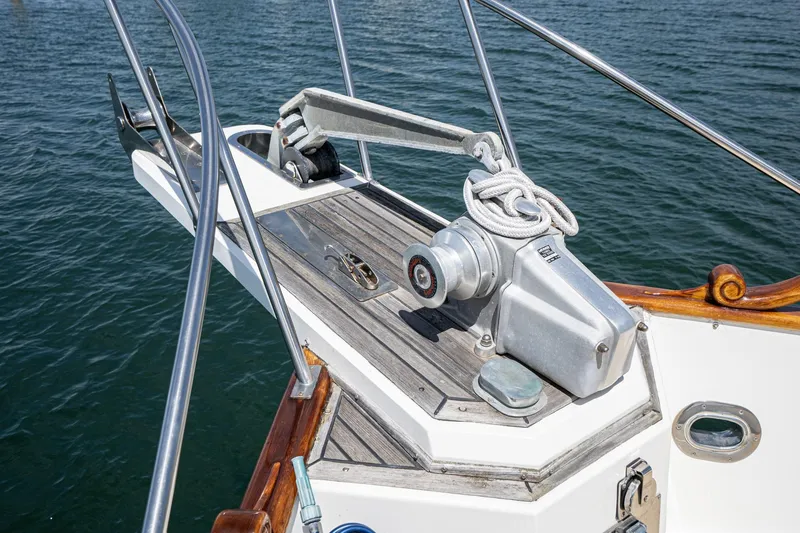 Slide: The Image of Bow of 1987 Grand Banks 46 Classic yacht with anchor winch and railing. - 10