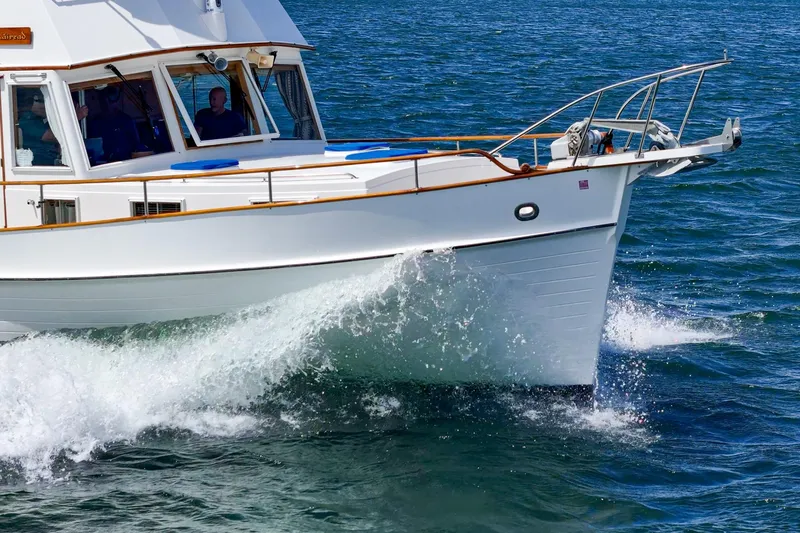 Slide: The Image of 1987 Grand Banks 46 Classic yacht cruising on open water. - 11
