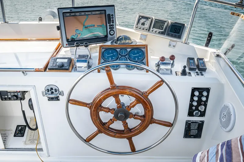 Slide: The Image of Helm of 1987 Grand Banks 46 Classic with navigation equipment and wooden steering wheel. - 16