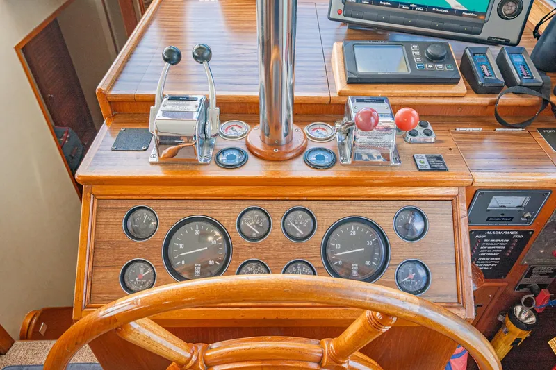 Slide: The Image of Helm of 1987 Grand Banks 46 Classic yacht with wooden dashboard and navigation instruments. - 38