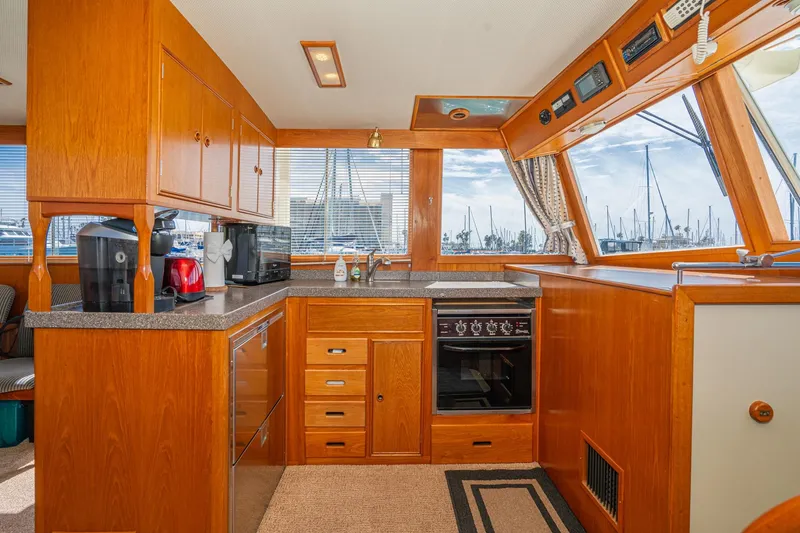 Slide: The Image of Interior of 1987 Grand Banks 46 Classic yacht kitchen with wooden cabinetry and modern appliances. - 40