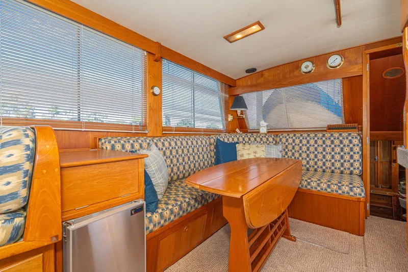 Slide: The Image of Interior of 1987 Grand Banks 46 Classic yacht with wood finish and patterned seating. - 46