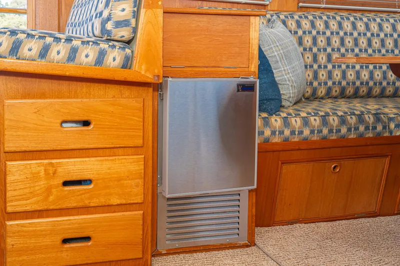 Slide: The Image of Interior of 1987 Grand Banks 46 Classic with wood cabinetry and patterned seating. - 47