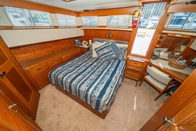 Slide: The Image of Cozy cabin interior of 1987 Grand Banks 46 Classic yacht with wood paneling and nautical decor. - 56