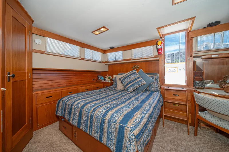 Slide: The Image of Cozy bedroom interior of 1987 Grand Banks 46 Classic yacht with wood paneling and nautical decor. - 57