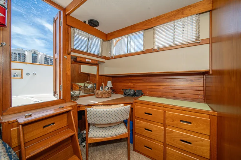 Slide: The Image of Interior of 1987 Grand Banks 46 Classic yacht with wooden cabinetry and desk area. - 60