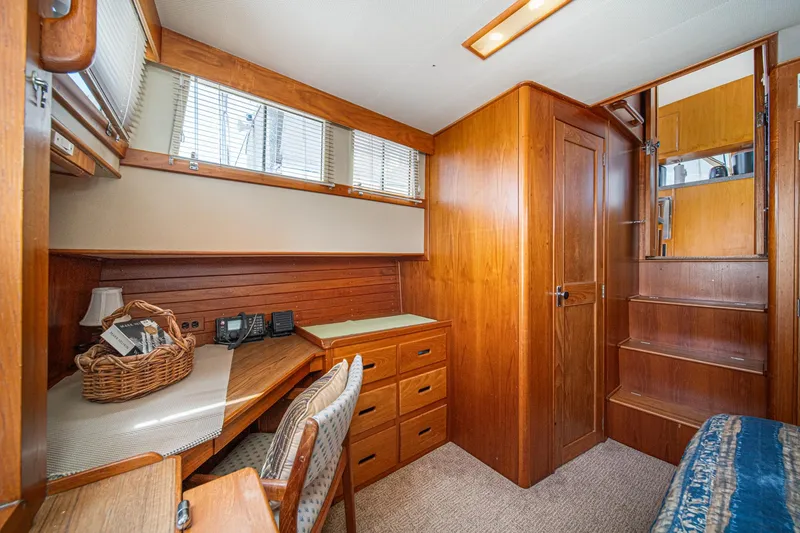 Slide: The Image of Interior of 1987 Grand Banks 46 Classic yacht with wooden cabinetry and desk area. - 61