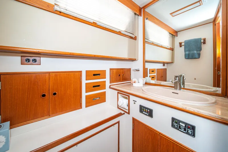 Slide: The Image of 1987 Grand Banks 46 Classic yacht bathroom with wooden cabinetry and modern fixtures. - 64