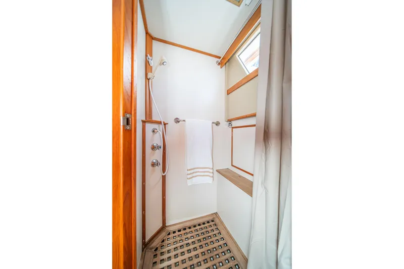 Slide: The Image of Shower area in 1987 Grand Banks 46 Classic yacht with wooden accents and towel rack. - 66