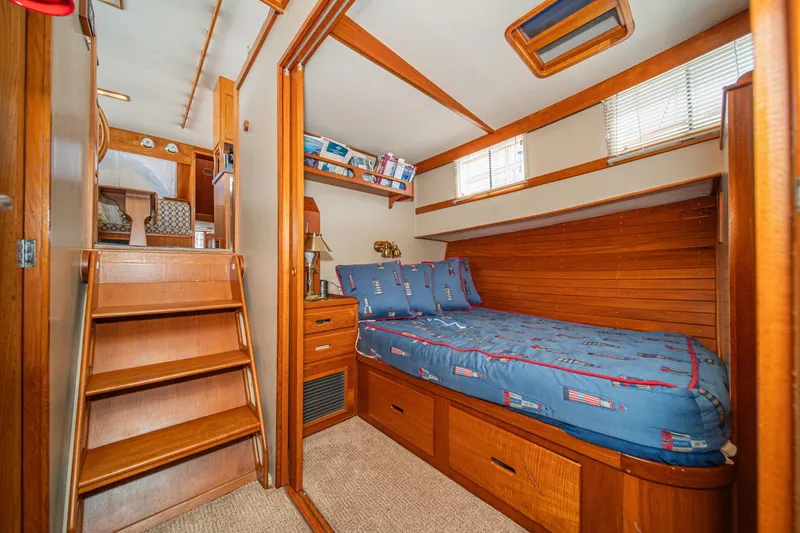 Slide: The Image of Cozy cabin interior of 1987 Grand Banks 46 Classic yacht with wooden furnishings and nautical bedding. - 68