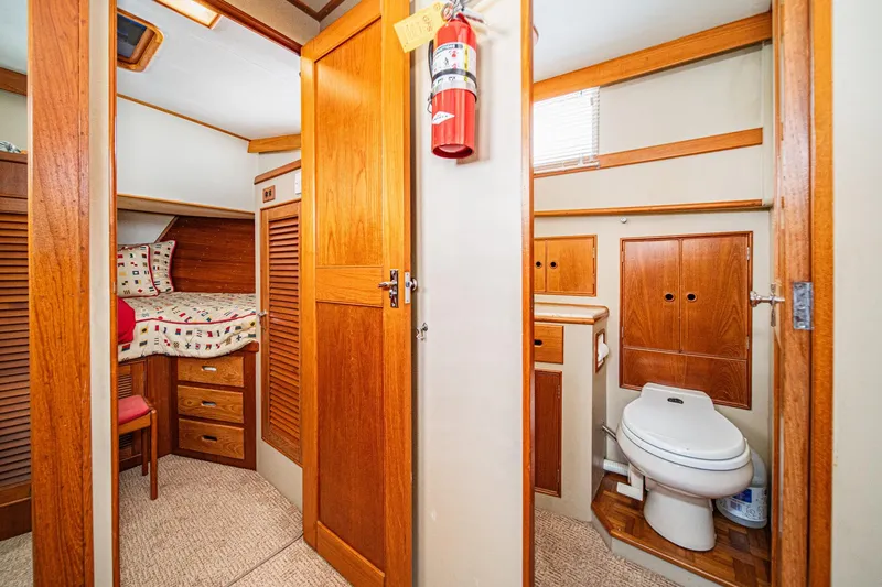Slide: The Image of Interior of 1987 Grand Banks 46 Classic yacht with wooden cabinetry and cozy sleeping area. - 73