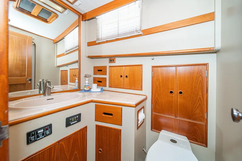 Slide: The Image of Elegant 1987 Grand Banks 46 Classic yacht bathroom with wood cabinetry and modern fixtures. - 74