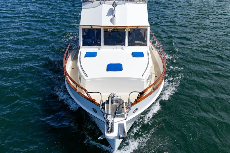 Slide: The Image of 1987 Grand Banks 46 Classic yacht cruising on open water, aerial view. - 8