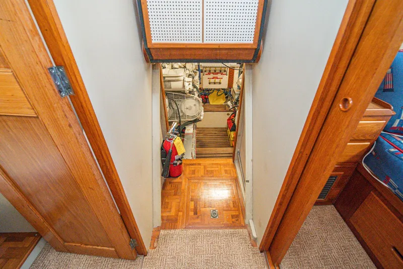 Slide: The Image of Engine room entrance of 1987 Grand Banks 46 Classic yacht, featuring wooden interior and equipment. - 81