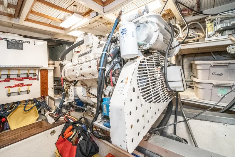 Slide: The Image of Engine room of a 1987 Grand Banks 46 Classic yacht, showcasing mechanical components. - 83