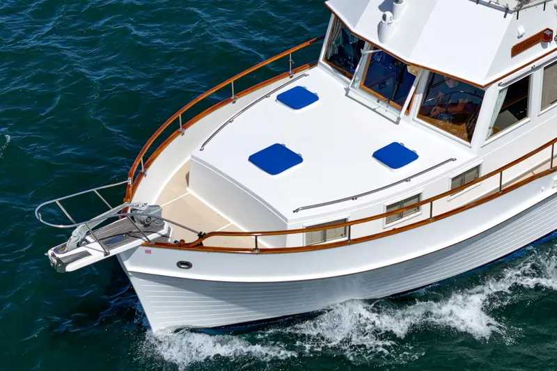 Slide: The Image of 1987 Grand Banks 46 Classic yacht cruising on blue ocean waters. - 9