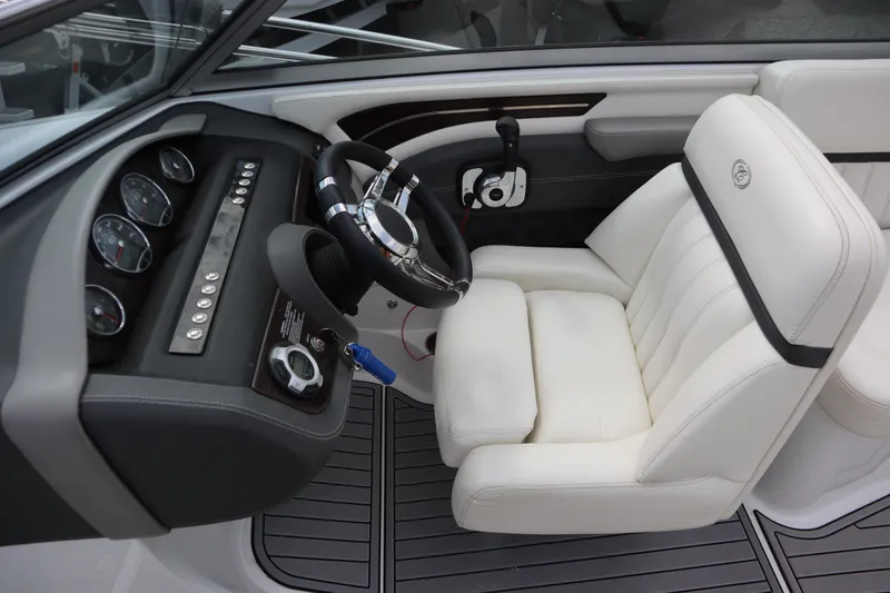 Slide: The Image of Cockpit of 2012 Cobalt A25 boat with white leather seat and modern dashboard controls. - 10