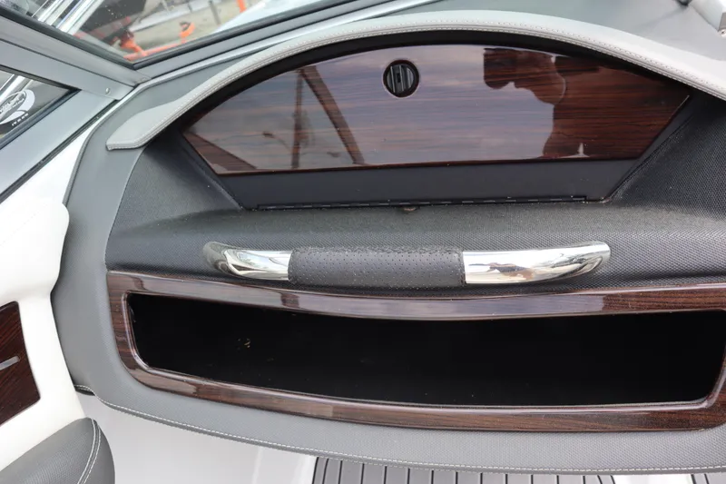 Slide: The Image of Interior detail of a 2012 Cobalt A25 boat, featuring a sleek storage compartment. - 14
