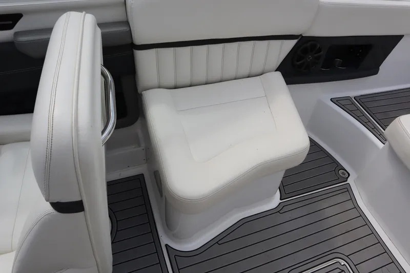 Slide: The Image of 2012 Cobalt A25 boat interior with white seating and gray flooring. - 16