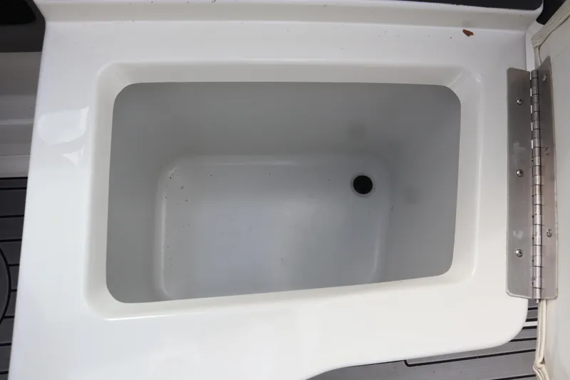 Slide: The Image of Open storage compartment in 2012 Cobalt A25 boat. - 17