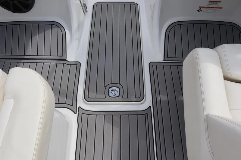 Slide: The Image of 2012 Cobalt A25 boat interior with gray decking and white seating. - 20