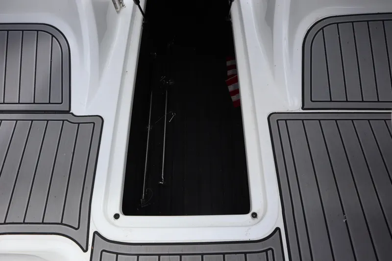 Slide: The Image of 2012 Cobalt A25 boat storage compartment with gray decking. - 21