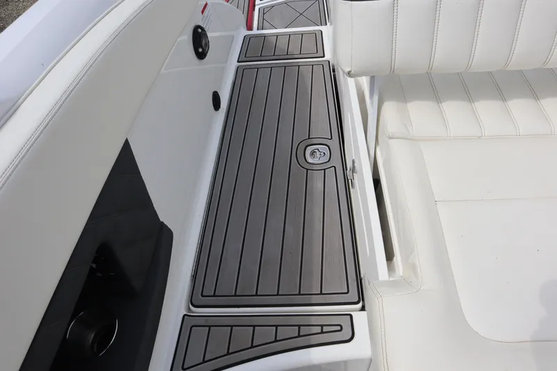 Slide: The Image of 2012 Cobalt A25 boat interior with white seating and sleek deck design. - 24
