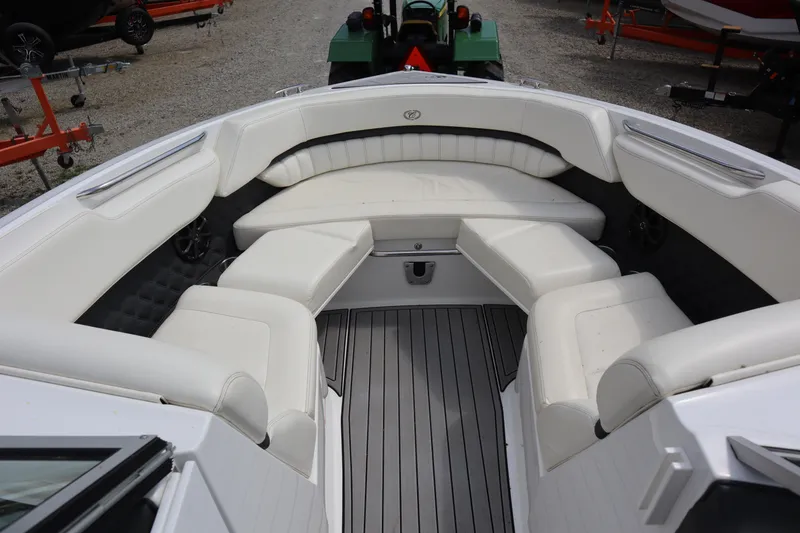 Slide: The Image of 2012 Cobalt A25 boat interior with white seating and gray flooring. - 3