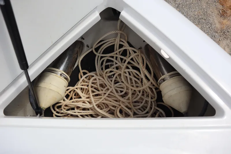 Slide: The Image of Storage compartment of a 2012 Cobalt A25 boat with coiled rope and fenders. - 8
