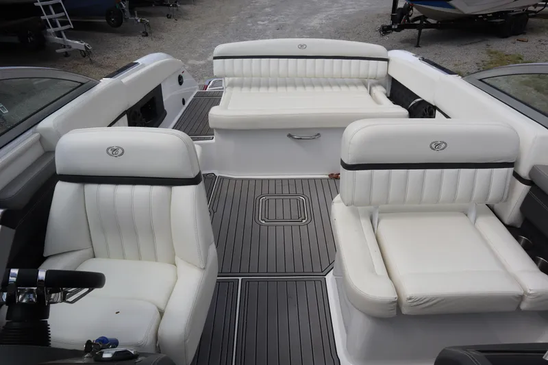 Slide: The Image of 2012 Cobalt A25 boat interior with white leather seating and sleek design. - 9