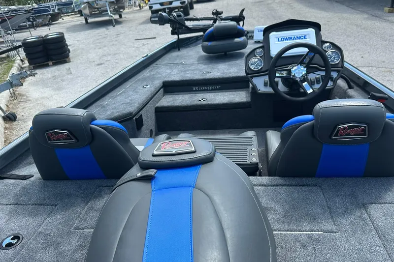 Slide: The Image of 2026 Ranger RT178 boat interior with blue and black seating, steering console, and Lowrance display. - 17