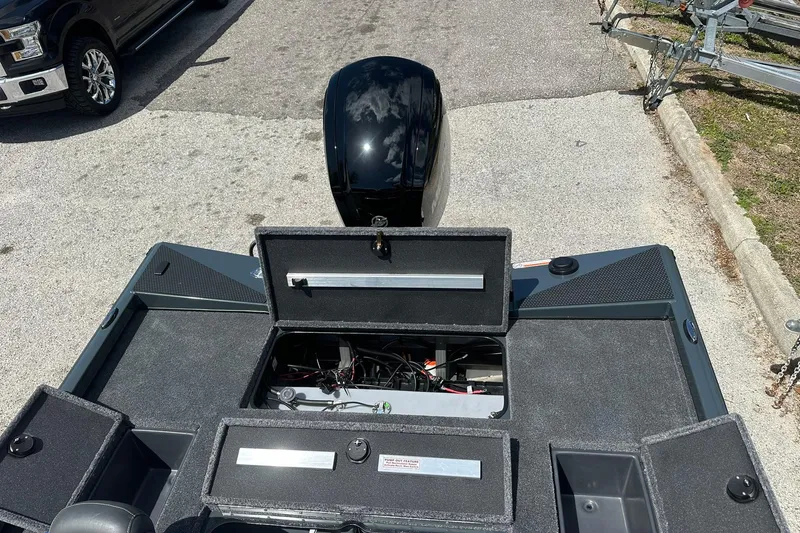 Slide: The Image of 2026 Ranger RT178 boat with open storage compartments and visible engine on a trailer. - 18