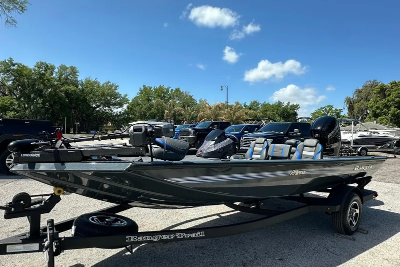 Slide: The Image of 2026 Ranger RT178 fishing boat on trailer, parked outdoors under clear blue sky. - 2