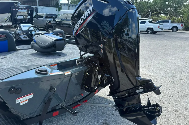 Slide: The Image of 2026 Ranger RT178 boat with Mercury outboard motor in a parking lot. - 20