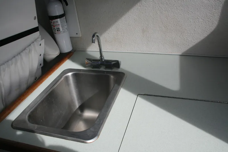 Slide: The Image of 2003 SeaSport Explorer 2400 boat interior with sink and faucet. - 12