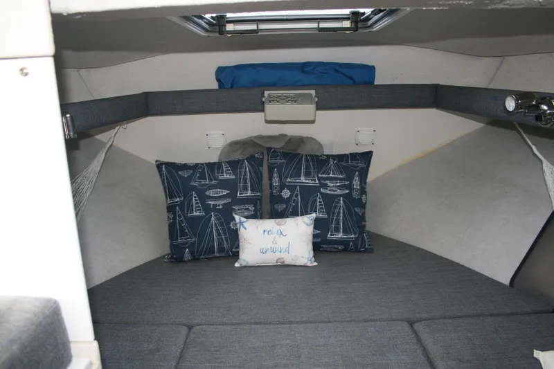 Slide: The Image of Cozy cabin interior of 2003 SeaSport Explorer 2400 with nautical-themed pillows. - 14
